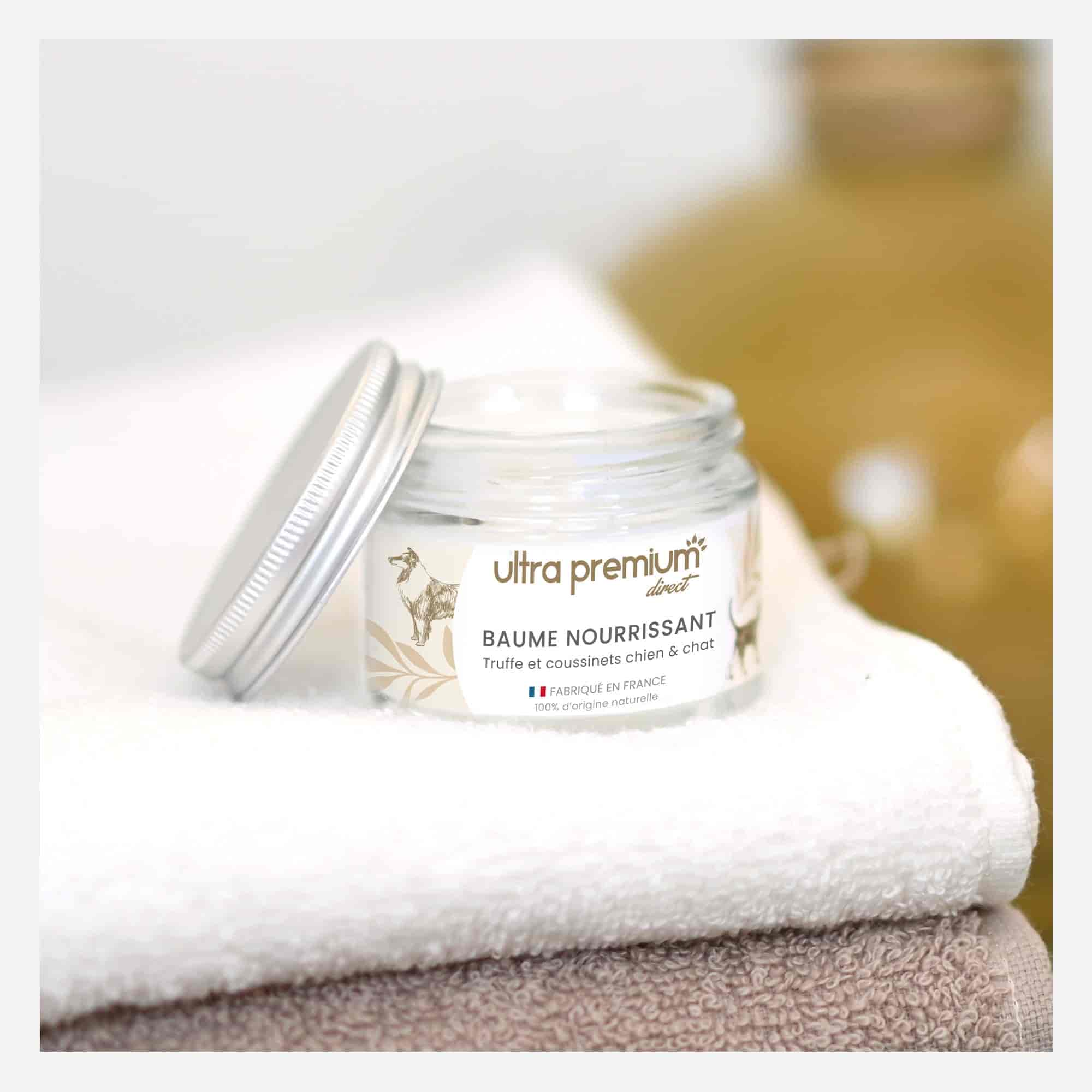 Pot ouvert de Baume nourrissant pour truffe et coussinets sur des serviettes